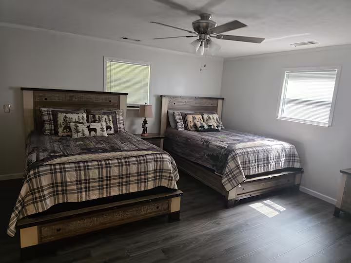 A bedroom at Family Times Cabin with two beds and patterned bedding.